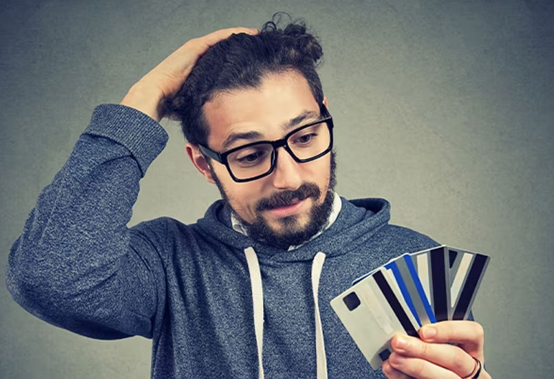 man looking at credit card